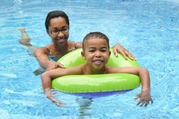 little boy in an inner tube with mom