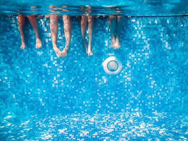 legs underwater in a swimming pool