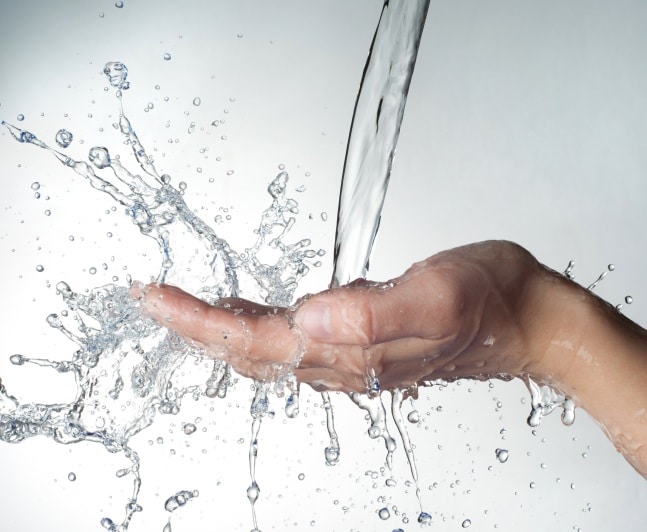 water splashing into hand