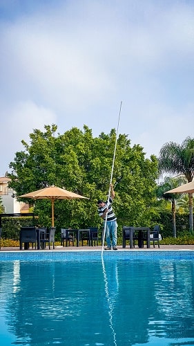 man is cleaning a pool