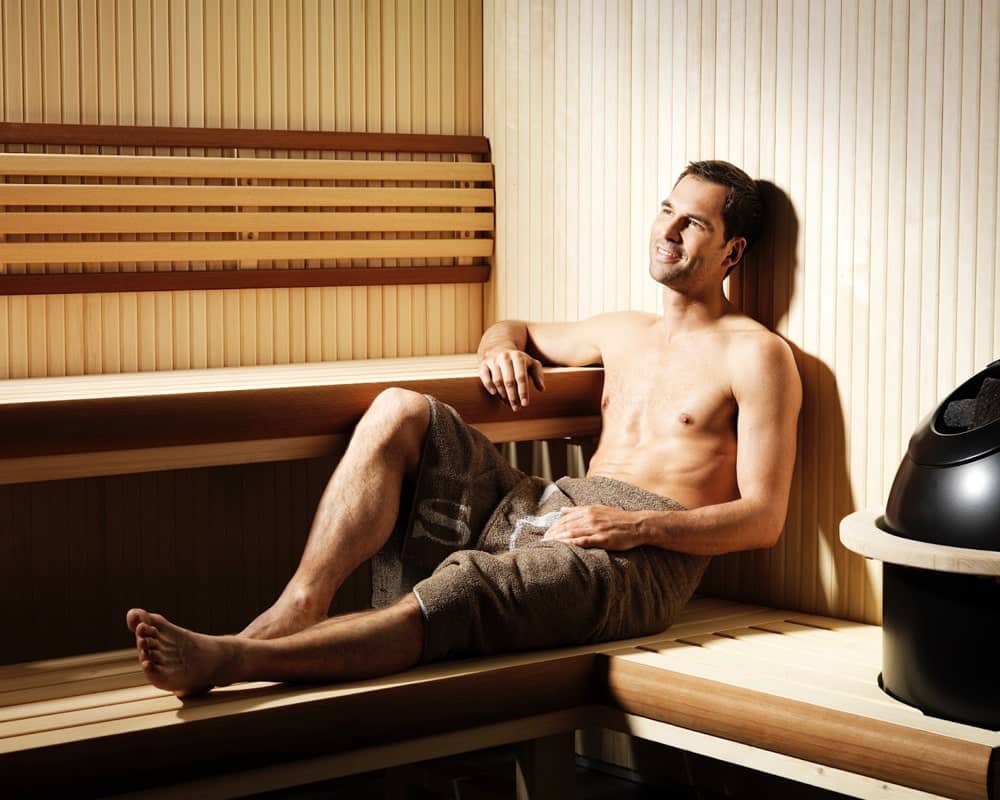 man sitting in a sauna