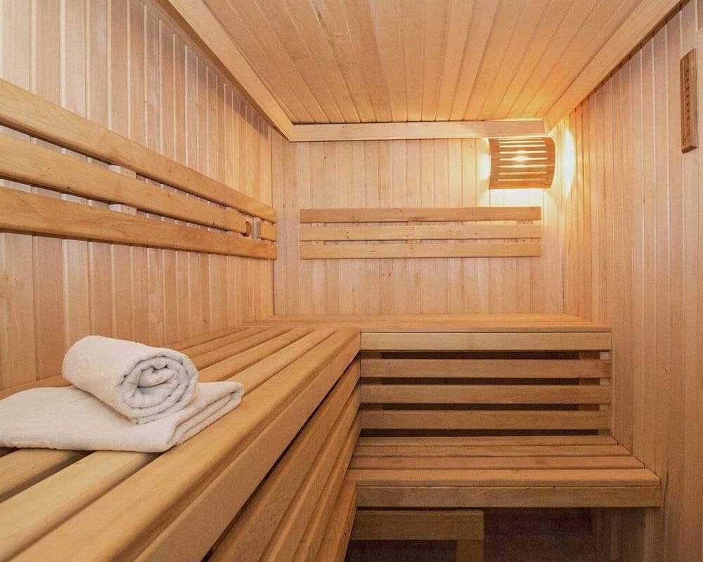 sauna interior with towels on wooden bench